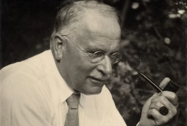 Swiss psychiatrist and psychotherapist Karl Jung holding a smoking pipe