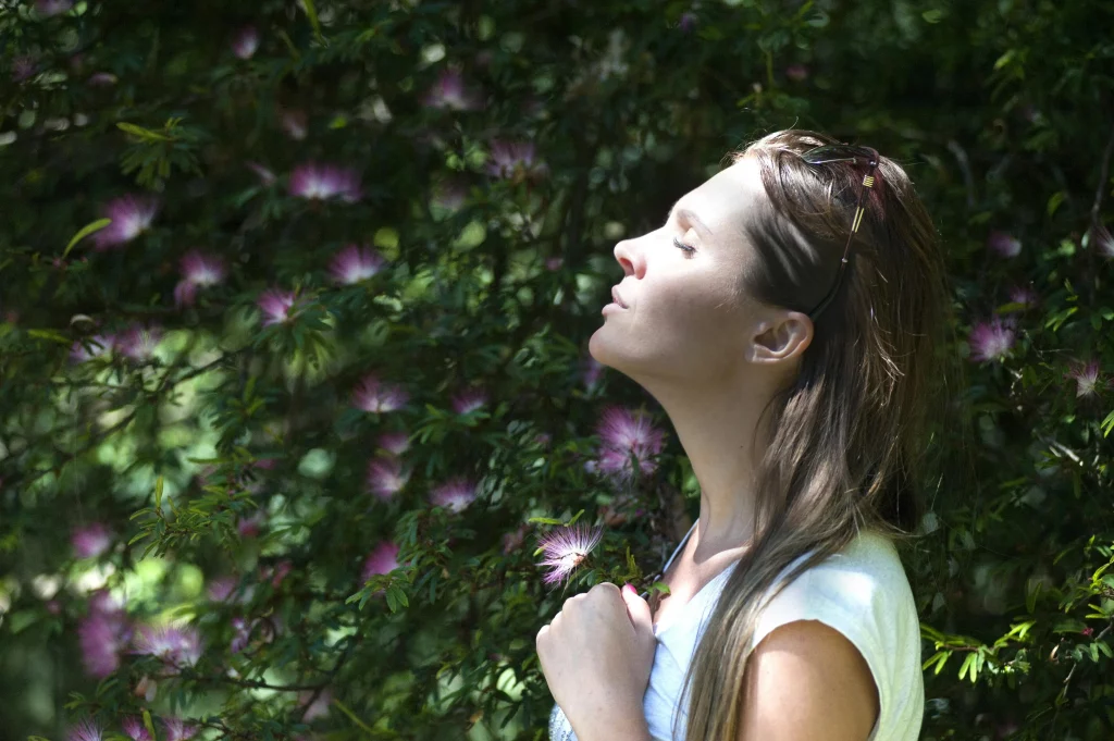 Woman Taking A Breath Sitting in Nature