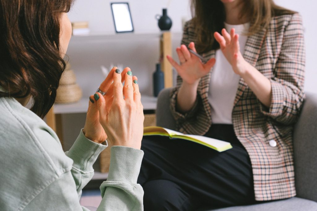 Two women sitting down having a business conversation