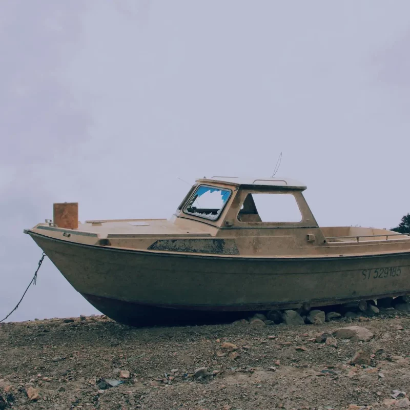 Image of a rusty boat on a beach