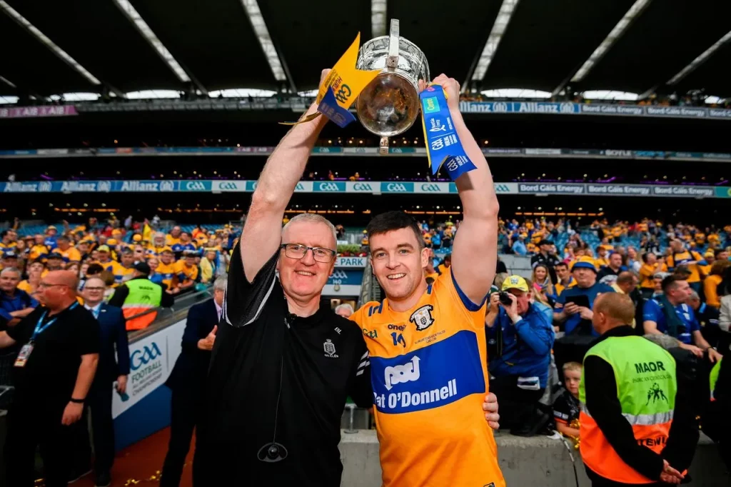 Clare Hurling Manager and Team Captain raise winning hurling all ireland trophy over their heads