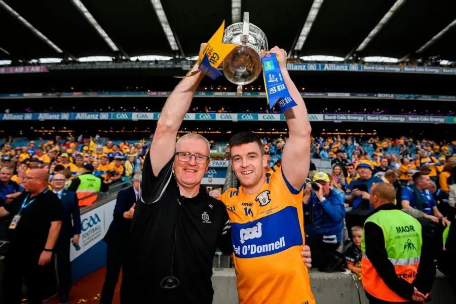 Clare Hurling Manager and Team Captain raise winning hurling all ireland trophy over their heads.